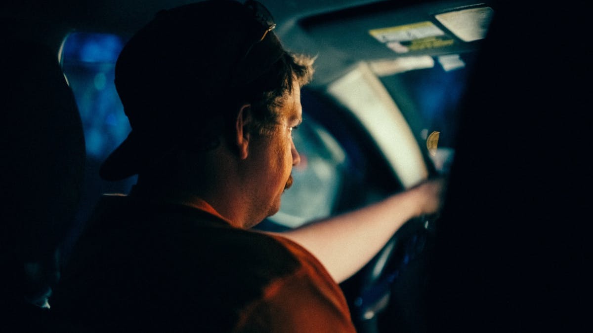 Contractor driving to job sites for progress updates.