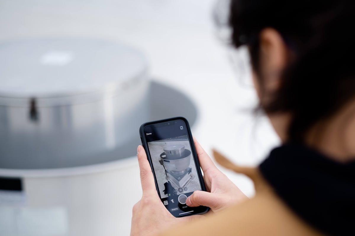hvac tech Person taking a photo of equipment with their phone camera on the companycam app